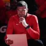 FILE - Portland Trail Blazers interim head coach Tiago Splitter listens during introductions before an NBA basketball game against the Brooklyn Nets, March 23, 2026, in Portland, Ore. (AP Photo/Jenny Kane, File)