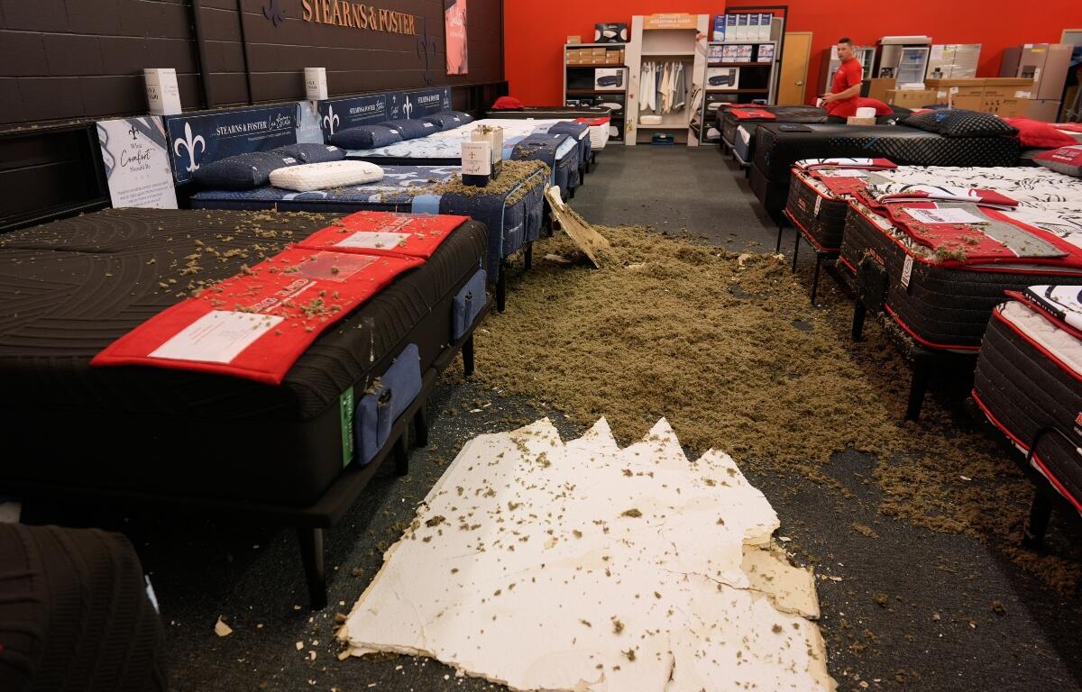 Damage from a collapsed roof is seen at Big Red Appliances & Mattresses in Florence, Ky, Thursday, June 18, 2026, after severe weather moved through the region. (AP Photo/Carolyn Kaster)