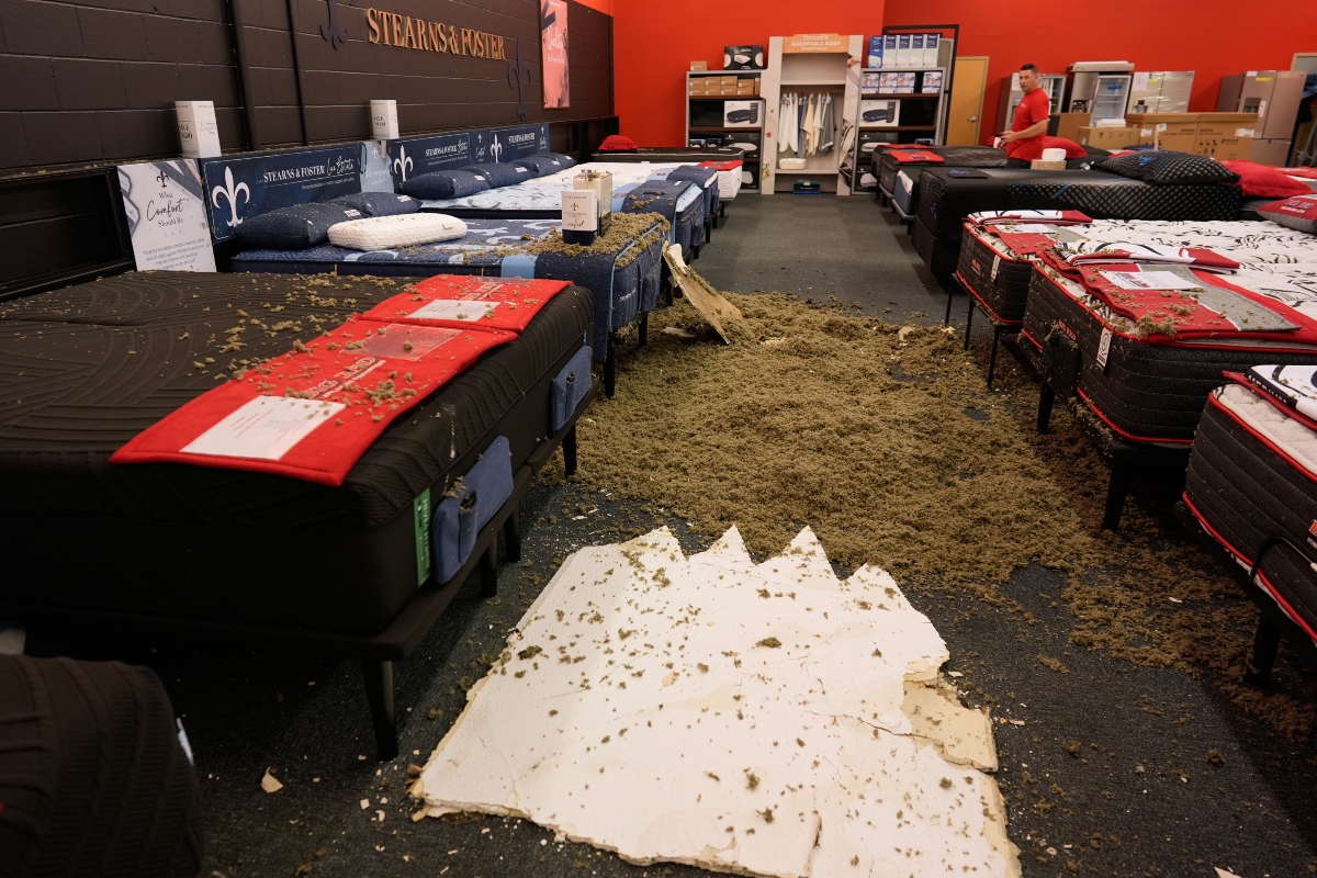 Damage from a collapsed roof is seen at Big Red Appliances & Mattresses in Florence, Ky, Thursday, June 18, 2026, after severe weather moved through the region. (AP Photo/Carolyn Kaster)