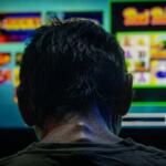 A man spends the last three dollars in his pocket playing a bar slot machine in downstate Golconda on June 4, and then leaves. (Credit: Julia Rendleman for Capitol News Illinois)