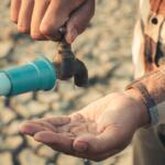 Hand for drinking water to live through drought, Concept drought and crisis environment.