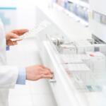 Pharmacist filling prescription in pharmacy