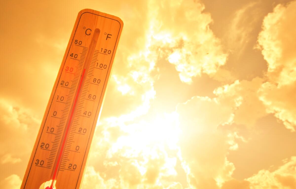 Thermometer against background hot, summer yellow sun. Hot weather and high air temperature.