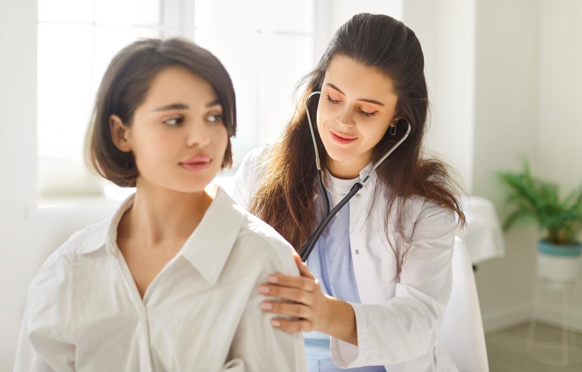 A doctor giving a physical.