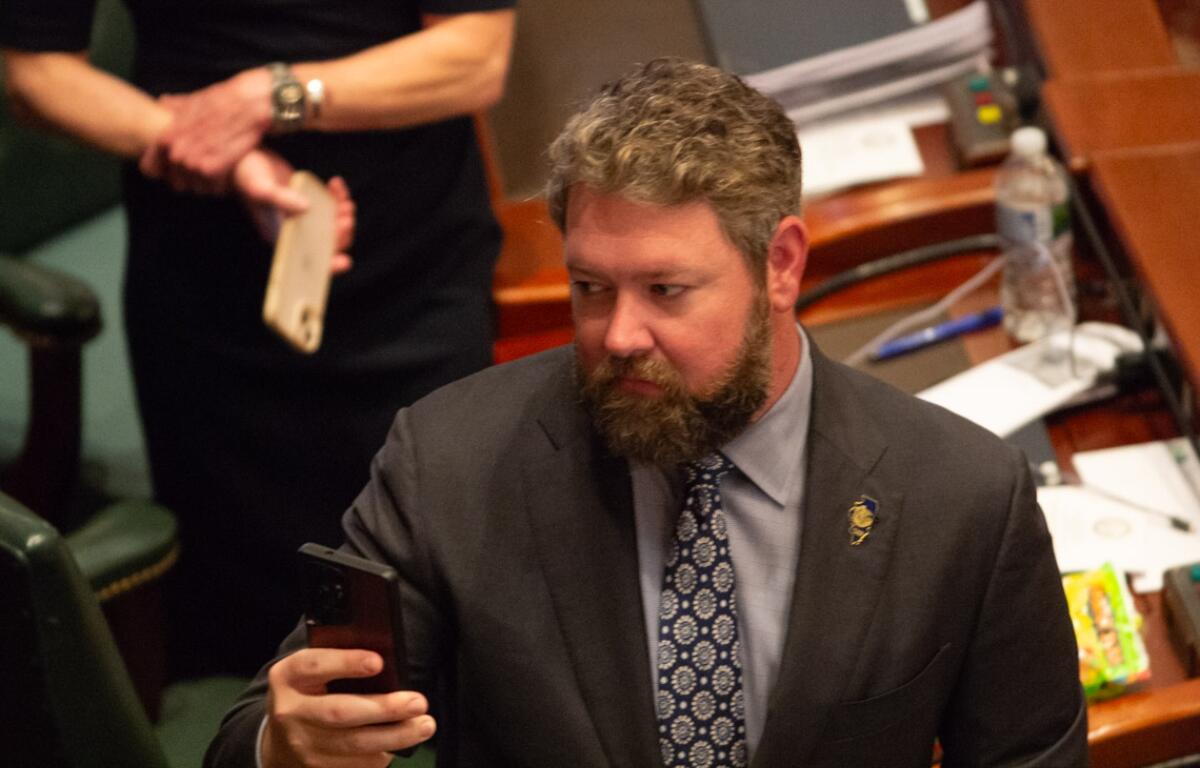 Rep. Harry Benton takes a picture during a joint session of the Illinois House in May 2026. (Capitol News Illinois photo by Jerry Nowicki)