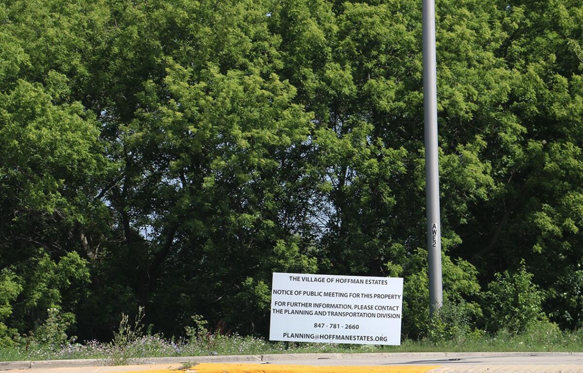 A sign provides notice for a public meeting of the Hoffman Estates Plan Commission to discuss rezoning the 186-acre property at Higgins Road and Route 59. The developer notified the village on July 1 that it would withdraw the rezoning request after community backlash. (Capitol News Illinois photo by Maggie Dougherty)