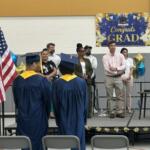 Traci Kinsley (at podium), principal of the high school at Monarch Youth Center, speaks to the graduates Monday, June 29.