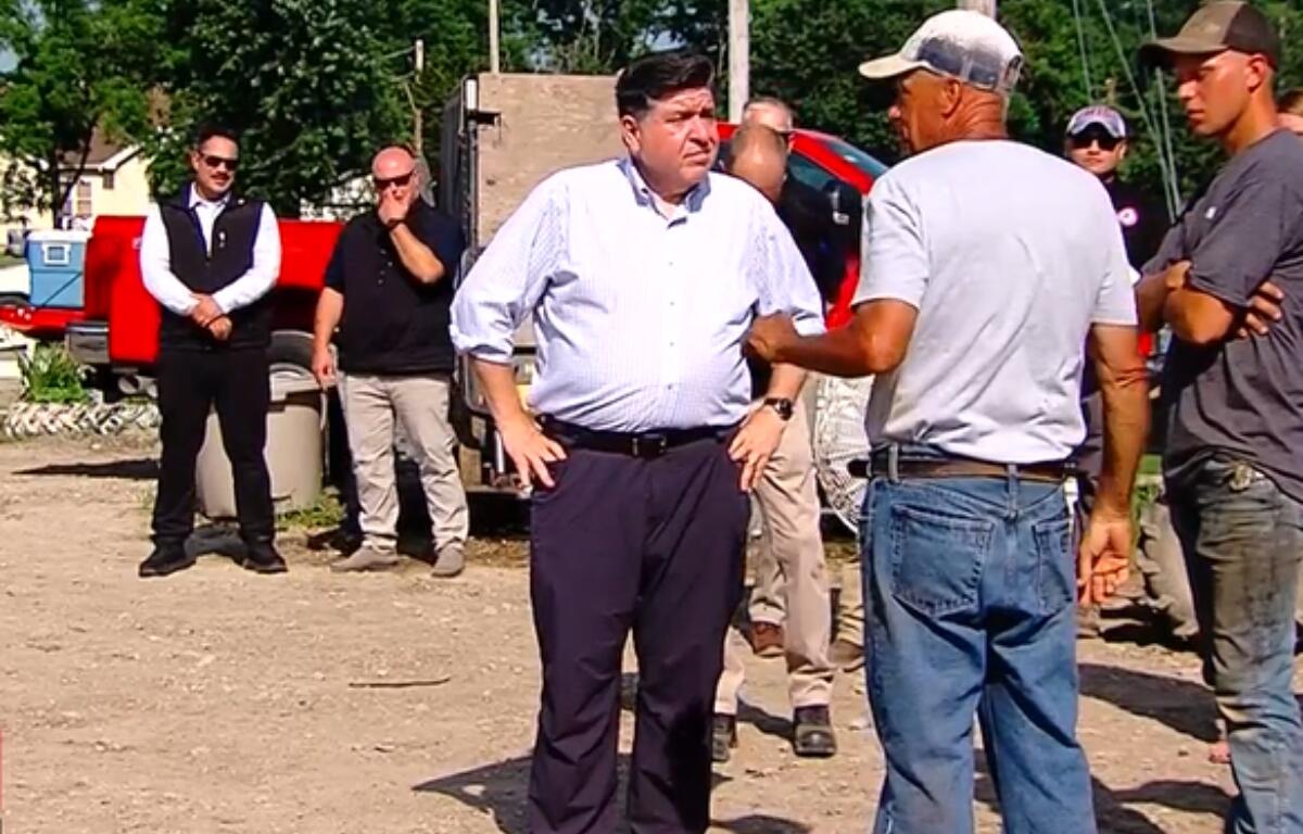 Governor JB Pritzker talks with storm cleanup workers in Effingham Wednesday, July 1.