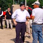 Governor JB Pritzker talks with storm cleanup workers in Effingham Wednesday, July 1.