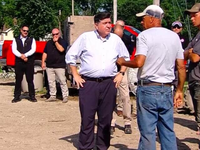 Governor JB Pritzker talks with storm cleanup workers in Effingham Wednesday, July 1.