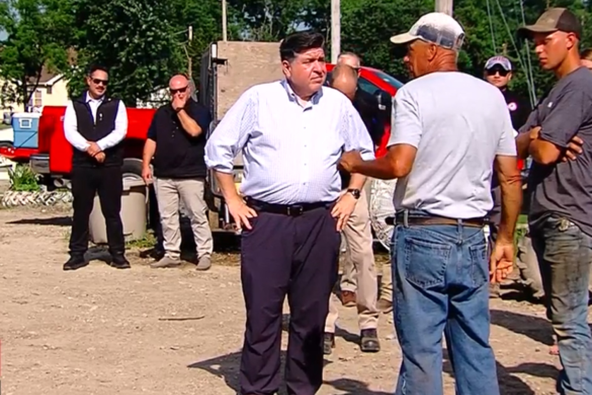 Governor JB Pritzker talks with storm cleanup workers in Effingham Wednesday, July 1.