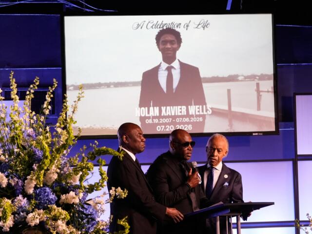 Elmore Wonsley, center, speaks next to attorney Ben Crump, left, and Rev. Al Sharpton during a memorial service for Nolan Xavier Wells, an 18-year-old found dead after taking a July 4 boat trip with friends, Monday, July 20, 2026, in Ocean Springs, Miss. (AP Photo/Gerald Herbert)