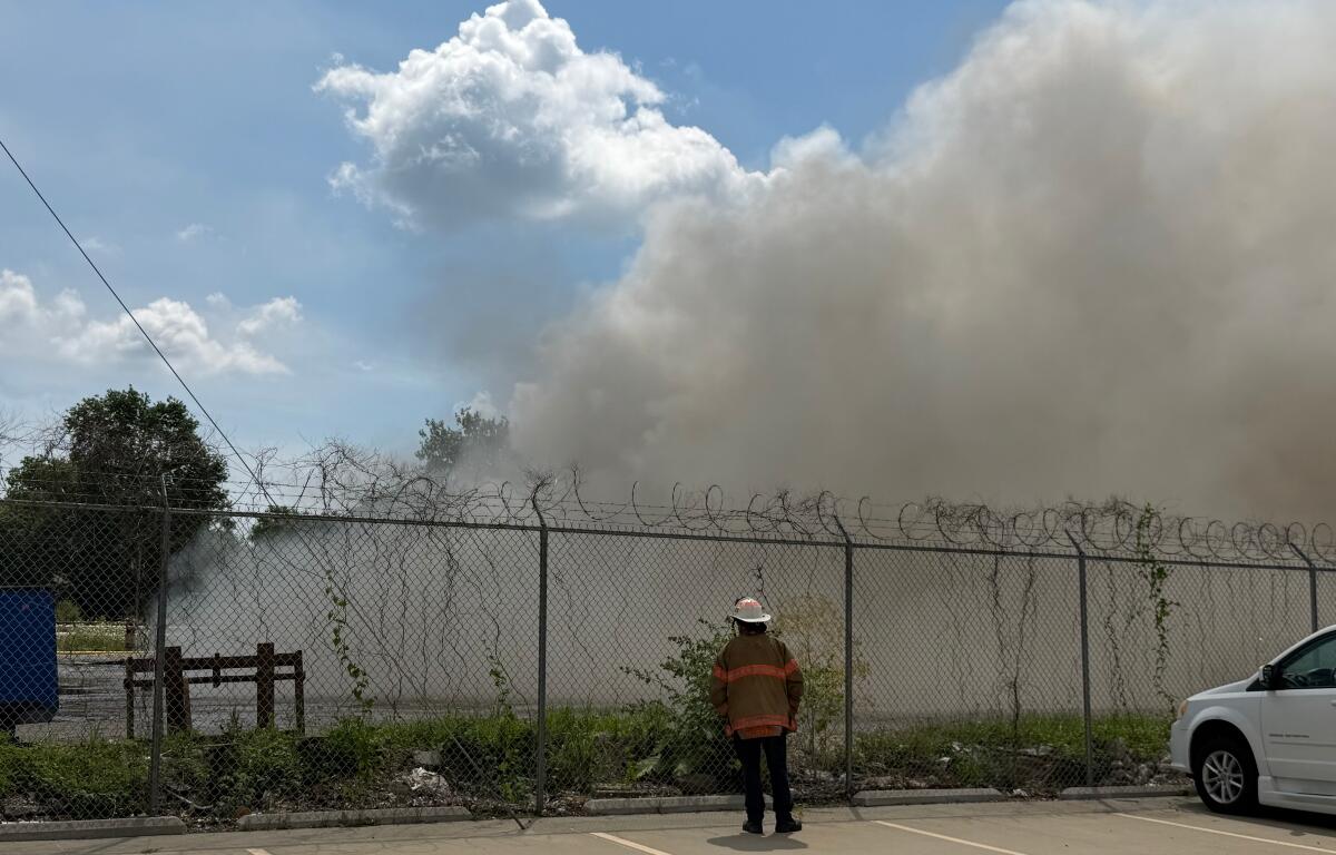 A Springfield firefighter stands watch at a fire at Mervis Recycling, 1100 S. 9th, Springfield.