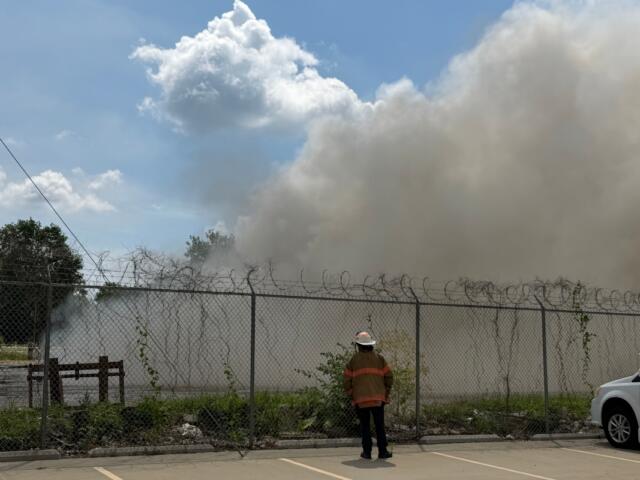 A Springfield firefighter stands watch at a fire at Mervis Recycling, 1100 S. 9th, Springfield.