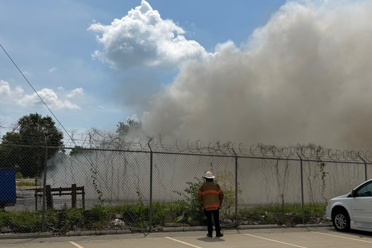 A Springfield firefighter stands watch at a fire at Mervis Recycling, 1100 S. 9th, Springfield.