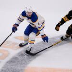 FILE - Buffalo Sabres defenseman Bowen Byram (4) controls the puck against Boston Bruins right wing David Pastrnak (88) during Game 3 of a first-round NHL hockey Stanley Cup playoff series, April 23, 2026, in Boston. (AP Photo/Charles Krupa, File)