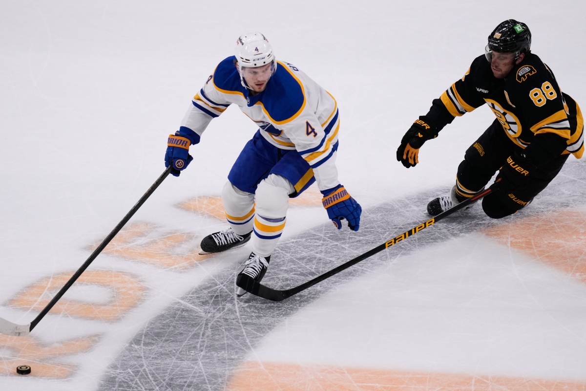 FILE - Buffalo Sabres defenseman Bowen Byram (4) controls the puck against Boston Bruins right wing David Pastrnak (88) during Game 3 of a first-round NHL hockey Stanley Cup playoff series, April 23, 2026, in Boston. (AP Photo/Charles Krupa, File)