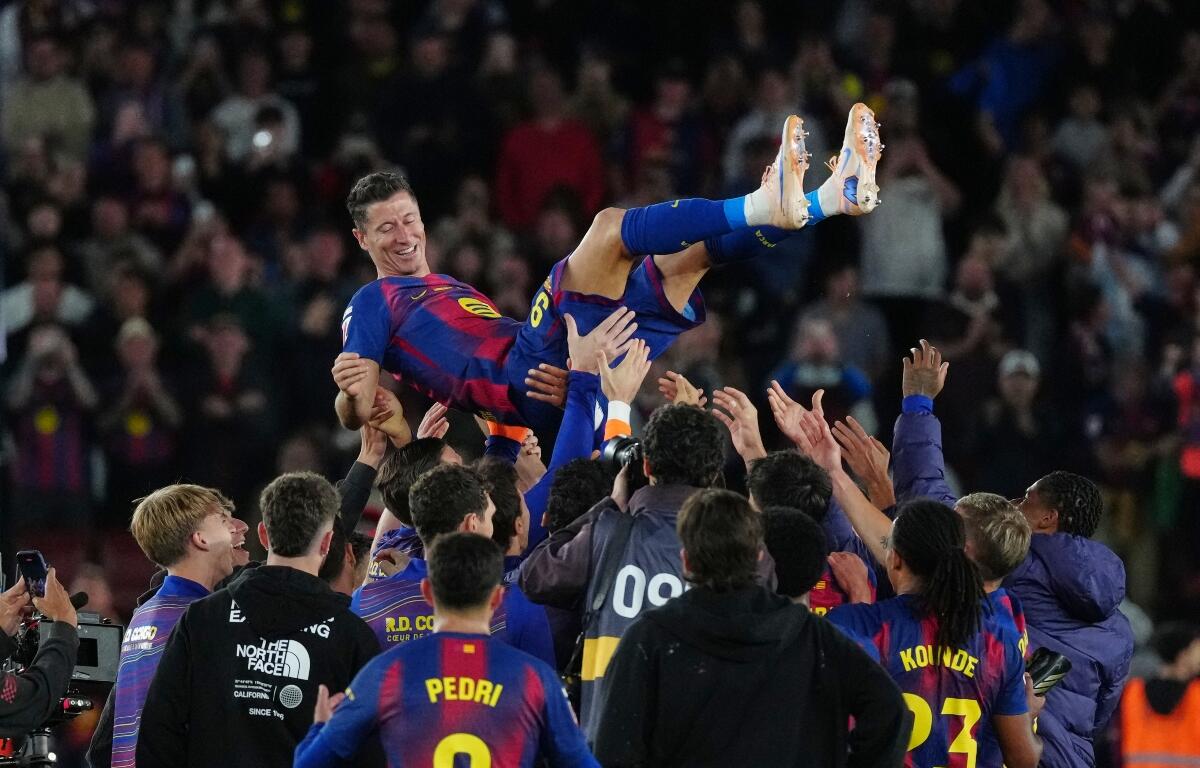 FILE - Barcelona's Robert Lewandowski is thrown into the air by his teammates after his last game for the club at the end of the Spanish La Liga soccer match between FC Barcelona and Real Betis in Barcelona, Spain, May 17, 2026. (AP Photo/Joan Mateu Parra, File)