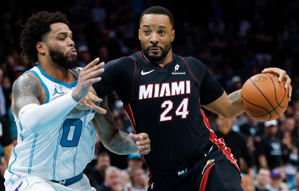 FILE - Miami Heat guard Norman Powell (24) drives to the basket against Charlotte Hornets forward Miles Bridges during the second half of an NBA play-in tournament basketball game in Charlotte, N.C., April 14, 2026. (AP Photo/Nell Redmond, File)