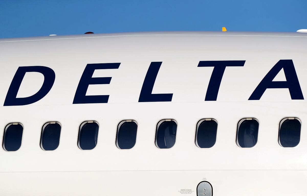 FILE - In this June 26, 2019, file photo, the company logo graces the side of a Delta Air Lines jetliner at Denver International Airport in Denver. (AP Photo/David Zalubowski, File)