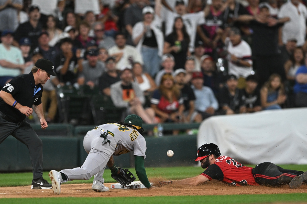 Chicago White Sox's Tristan Peters, right, slides safely into third base for an RBI triple while Athletics third baseman Joshua Kuroda-Grauer, center, catches the throw during the seventh inning of a baseball game in Chicago, Friday, July 10, 2026. (AP Photo/Paul Beaty)
