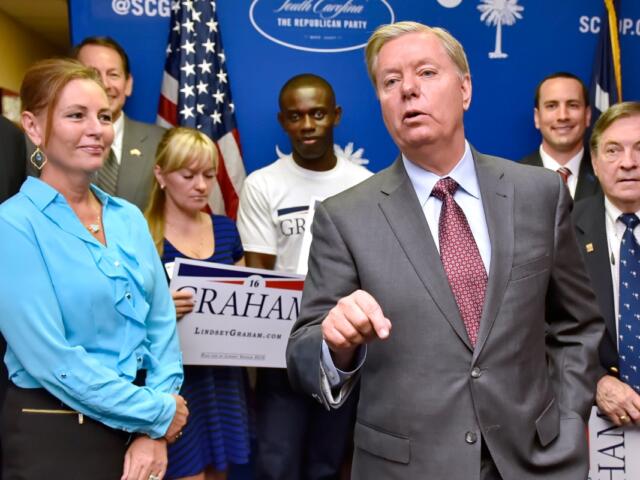FILE - Republican presidential candidate, Sen. Lindsey Graham, R-S.C., accompanied by his sister Darline, left, speaks at the GOP headquarters in Columbia, S.C., Sept. 1, 2015, where he filed for the South Carolina Presidential Primary. (AP Photo/Richard Shiro, File)
