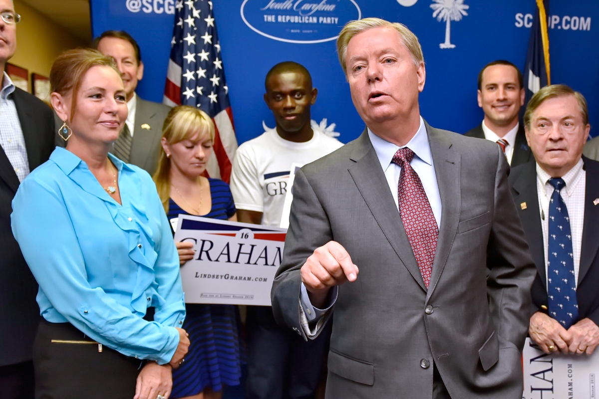 FILE - Republican presidential candidate, Sen. Lindsey Graham, R-S.C., accompanied by his sister Darline, left, speaks at the GOP headquarters in Columbia, S.C., Sept. 1, 2015, where he filed for the South Carolina Presidential Primary. (AP Photo/Richard Shiro, File)