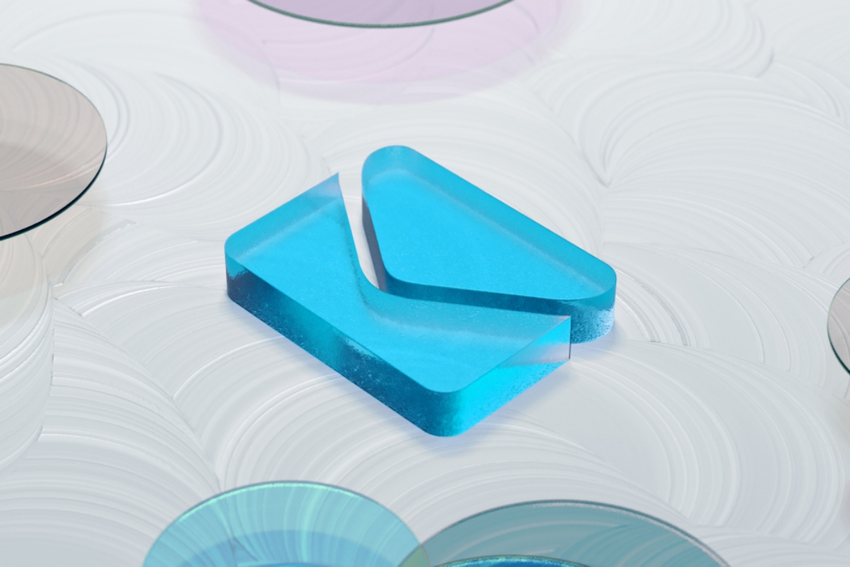 Blue translucent geometric block resting on a white swirled surface with circular reflective discs nearby (decorative image)