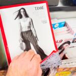Paris, France - Dec 28, 2024: A person flipping through Time magazine, featuring Caitlin Clark as Athlete of the Year with a basketball, alongside the CEO of the Year page.