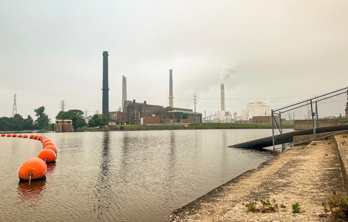Power station smoke stack chimney billows smoke into the air. Smoke from Canadian wildfires hangs heavy in the sky creating dangerous air quality conditions. Located in Central Illinois, USA.