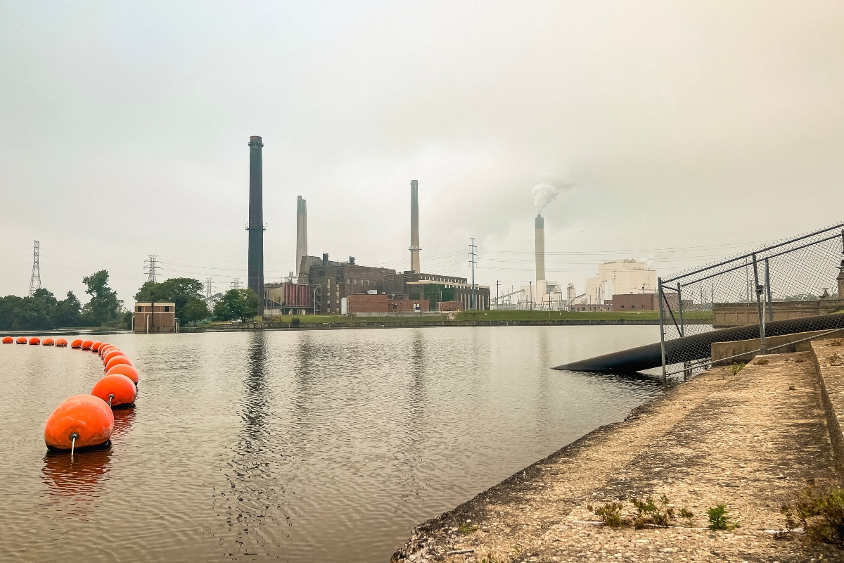 Power station smoke stack chimney billows smoke into the air. Smoke from Canadian wildfires hangs heavy in the sky creating dangerous air quality conditions. Located in Central Illinois, USA.
