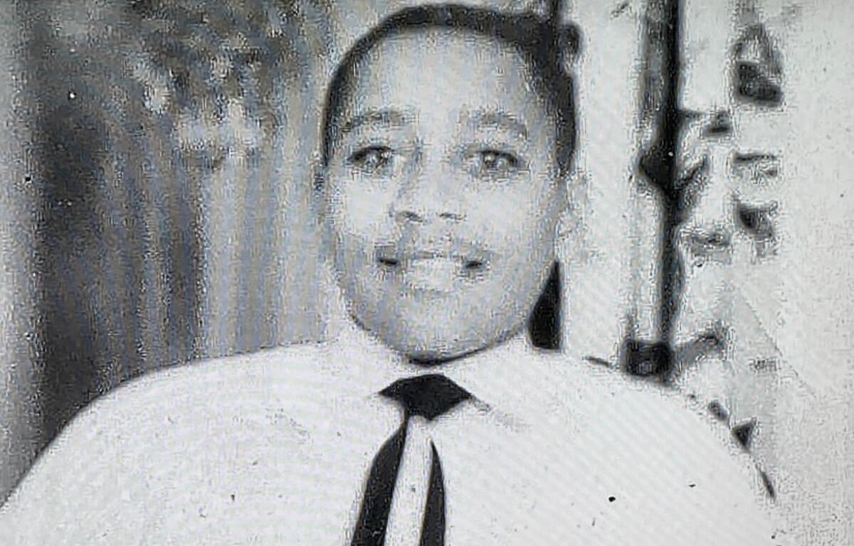 Smiling man in a white shirt and black tie looking at the camera. (Portrait)
