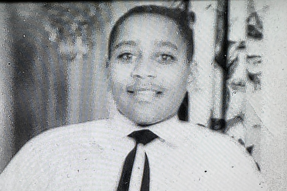 Smiling man in a white shirt and black tie looking at the camera. (Portrait)