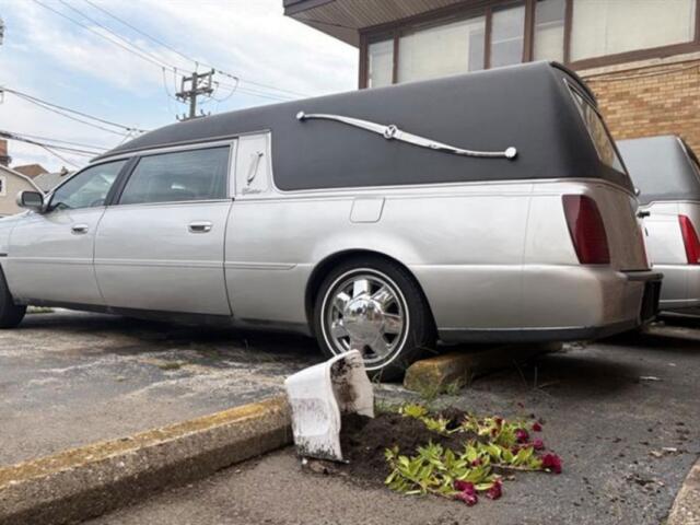 An overturned bin of flowers sits by parked hearses in the now-closed South Chicago Chapel. (Capitol News Illinois photo by Maggie Dougherty)