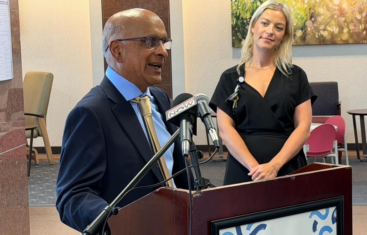 Dr. Babu Prasad, retired, talks about a $1 million donation made to HSHS St. John's Children's Hospital through its foundation, as foundation Director Ali Farmer looks on, Tuesday, August 11.