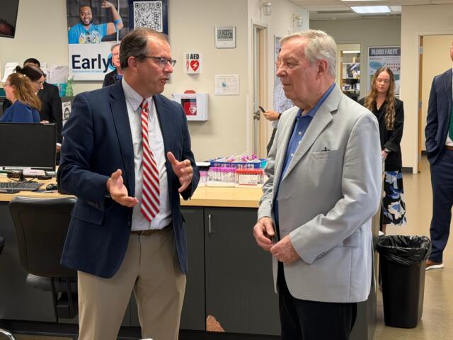 Sen. Dick Durbin (D-IL), right, speaks with Kirby Winn, spokesperson for ImpactLife blood centers.