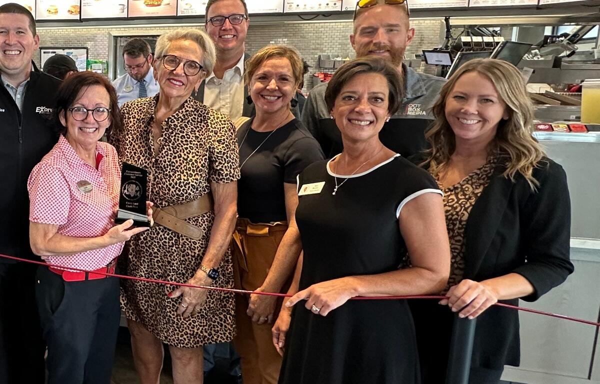 Amy Beadle, front dressed in a dark color with white trim, takes part in a Central Illinois Customer Service Association "WOW Award" presentation in October, 2025.