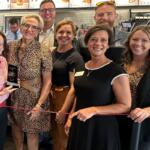 Amy Beadle, front dressed in a dark color with white trim, takes part in a Central Illinois Customer Service Association "WOW Award" presentation in October, 2025.