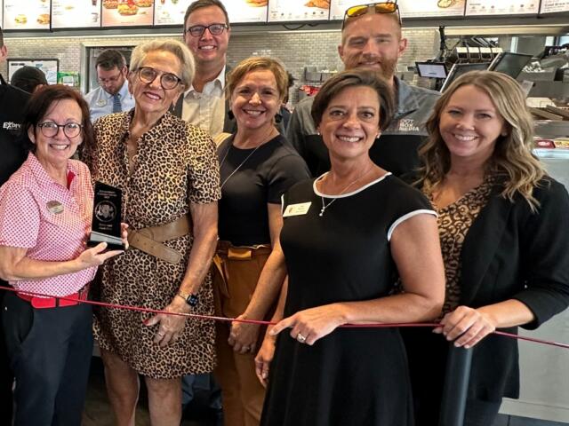 Amy Beadle, front dressed in a dark color with white trim, takes part in a Central Illinois Customer Service Association "WOW Award" presentation in October, 2025.