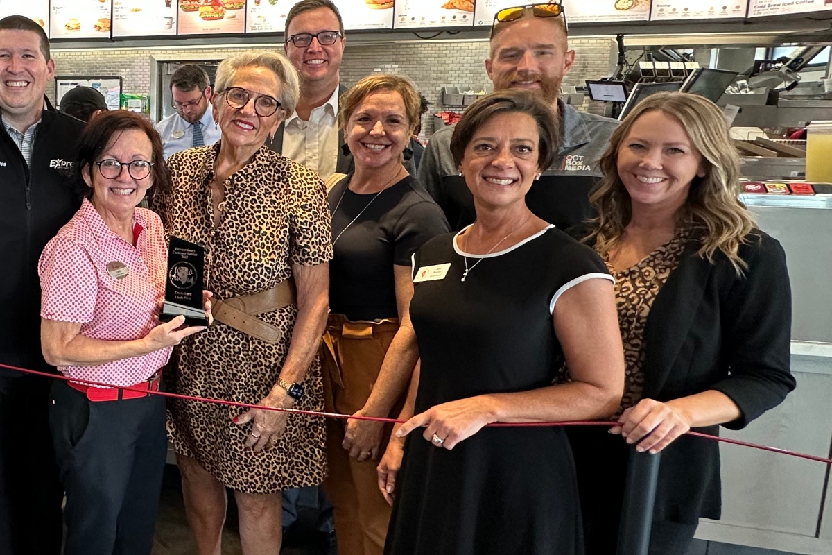 Amy Beadle, front dressed in a dark color with white trim, takes part in a Central Illinois Customer Service Association "WOW Award" presentation in October, 2025.