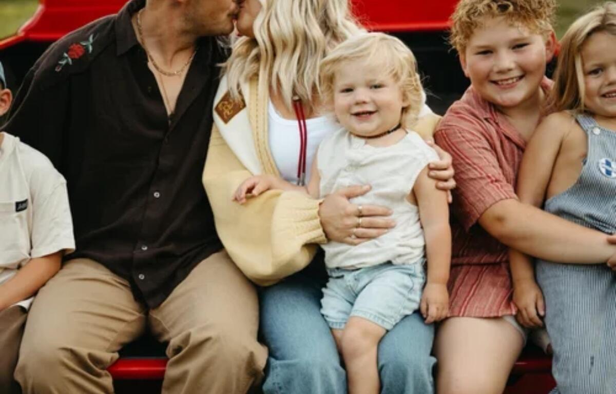 Hayes Johnson sits on his mother's lap in this photo.