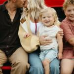 Hayes Johnson sits on his mother's lap in this photo.