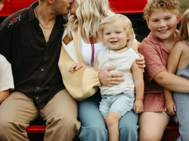 Hayes Johnson sits on his mother's lap in this photo.