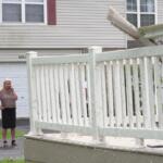 Kerry Hourigan speaks on the phone after reviewing damage a storm caused to her home in Tinley Park, Ill., Tuesday, Aug. 11, 2026. (AP Photo/Laura Bargfeld)
