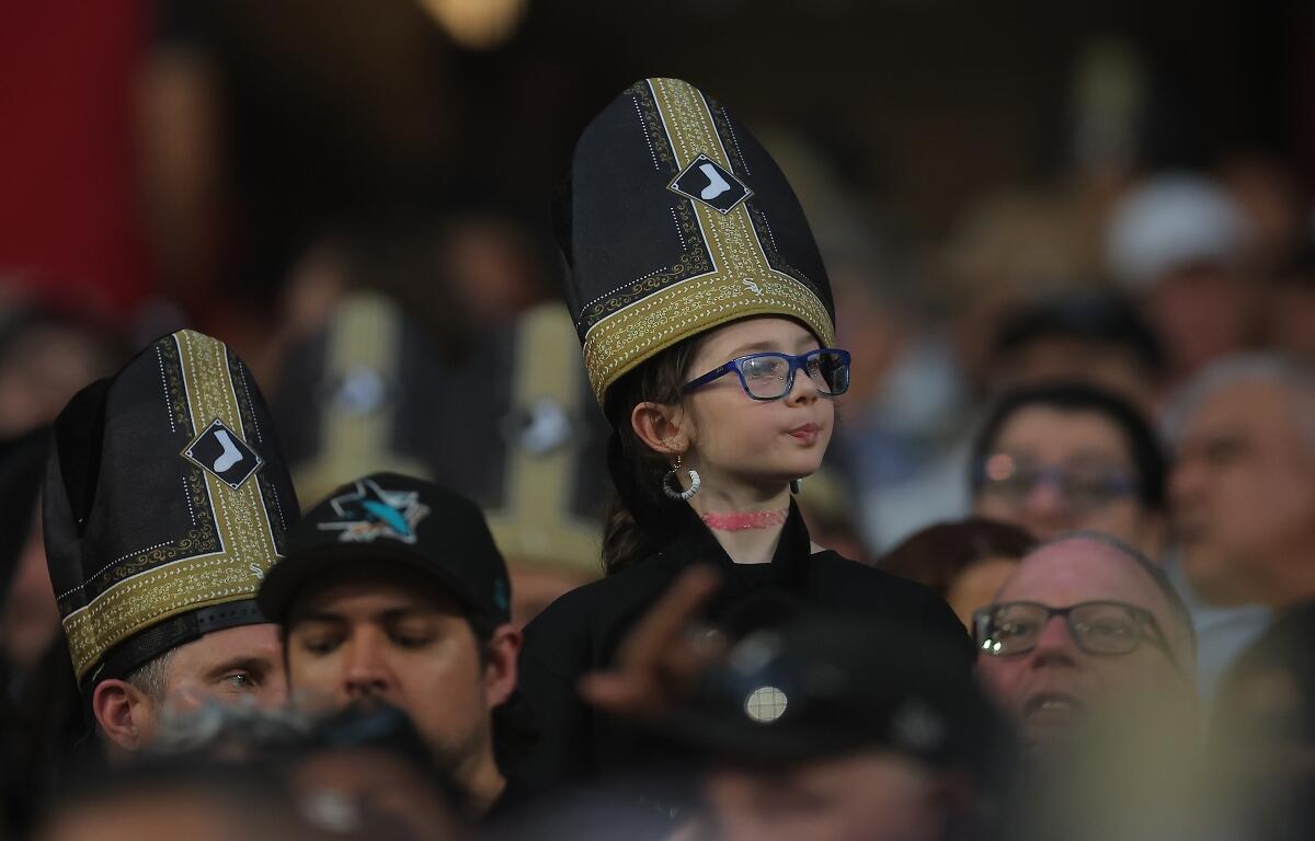 A fan wears a promotional pope hat during a baseball game between the Cincinnati Reds and Chicago White Sox, Tuesday, Aug. 11, 2026, in Chicago. (AP Photo/Melissa Tamez)