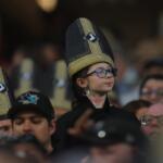A fan wears a promotional pope hat during a baseball game between the Cincinnati Reds and Chicago White Sox, Tuesday, Aug. 11, 2026, in Chicago. (AP Photo/Melissa Tamez)