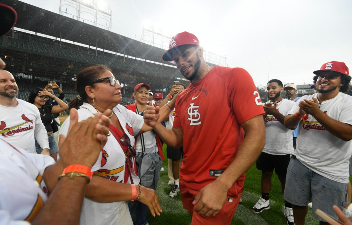 St. Louis Cardinals' Joshua Baez, right, celebrates with his mother Yris Carmen Baez, left, after defeating the Chicago Cubs in a baseball game in Chicago, Saturday, Aug. 15, 2026. (AP Photo/Paul Beaty)