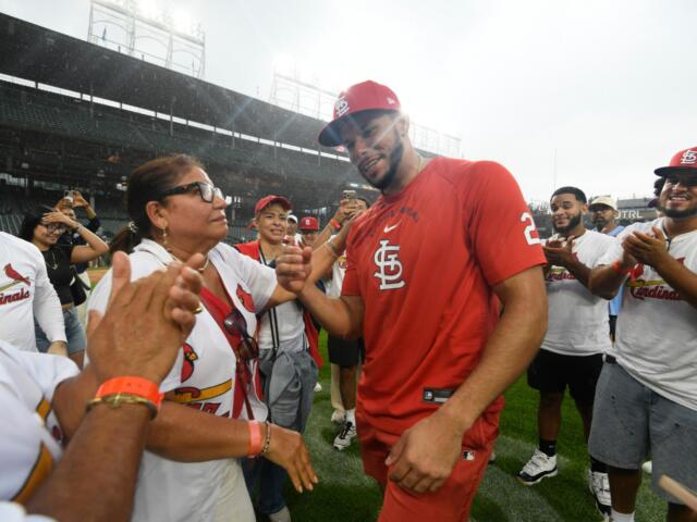 St. Louis Cardinals' Joshua Baez, right, celebrates with his mother Yris Carmen Baez, left, after defeating the Chicago Cubs in a baseball game in Chicago, Saturday, Aug. 15, 2026. (AP Photo/Paul Beaty)