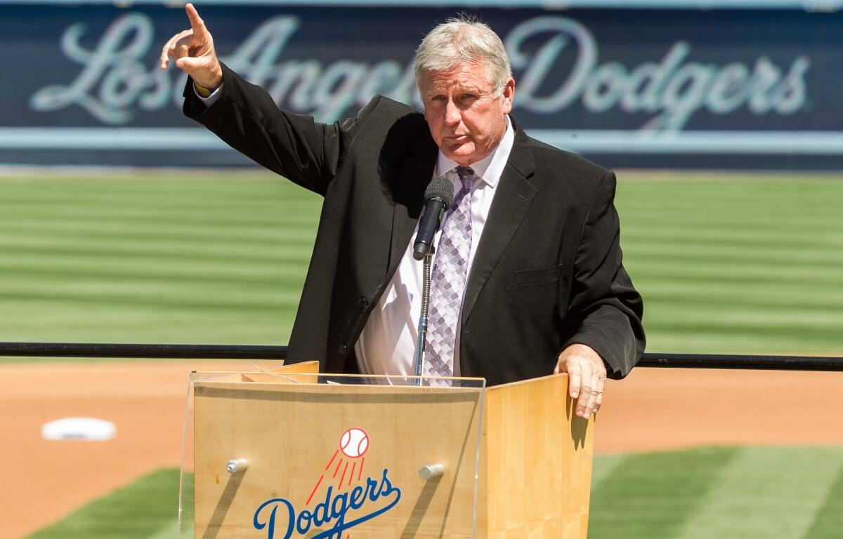FILE - Los Angeles Dodgers former pitcher Tommy John praises his late friend, Dr. Frank Jobe during a memorial service at Dodger Stadium in Los Angeles, April 7, 2014. (AP Photo/Damian Dovarganes, File)