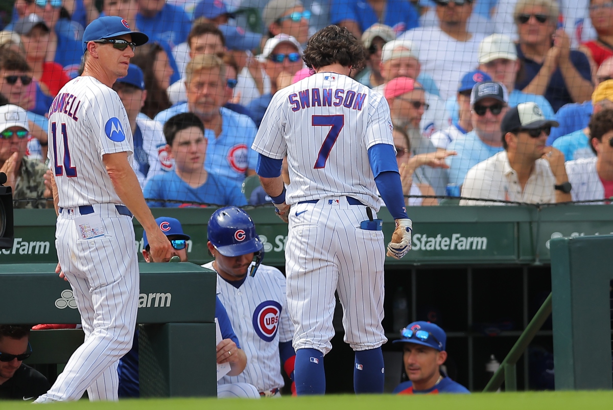 Chicago Cubs manager Craig Counsell, left, walks back to the dugout with Dansby Swanson (7) during the third inning of a baseball game against the St. Louis Cardinals, Sunday, Aug. 16, 2026, in Chicago. (AP Photo/Melissa Tamez)